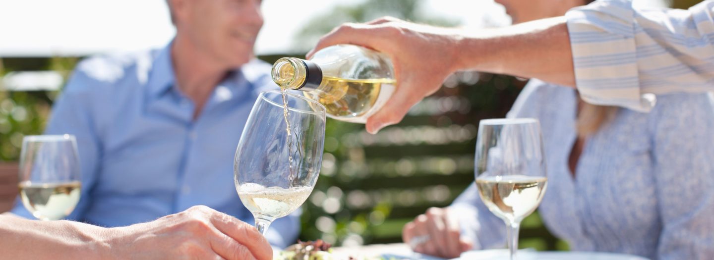 Group sharing wine at holiday cottage in Devon