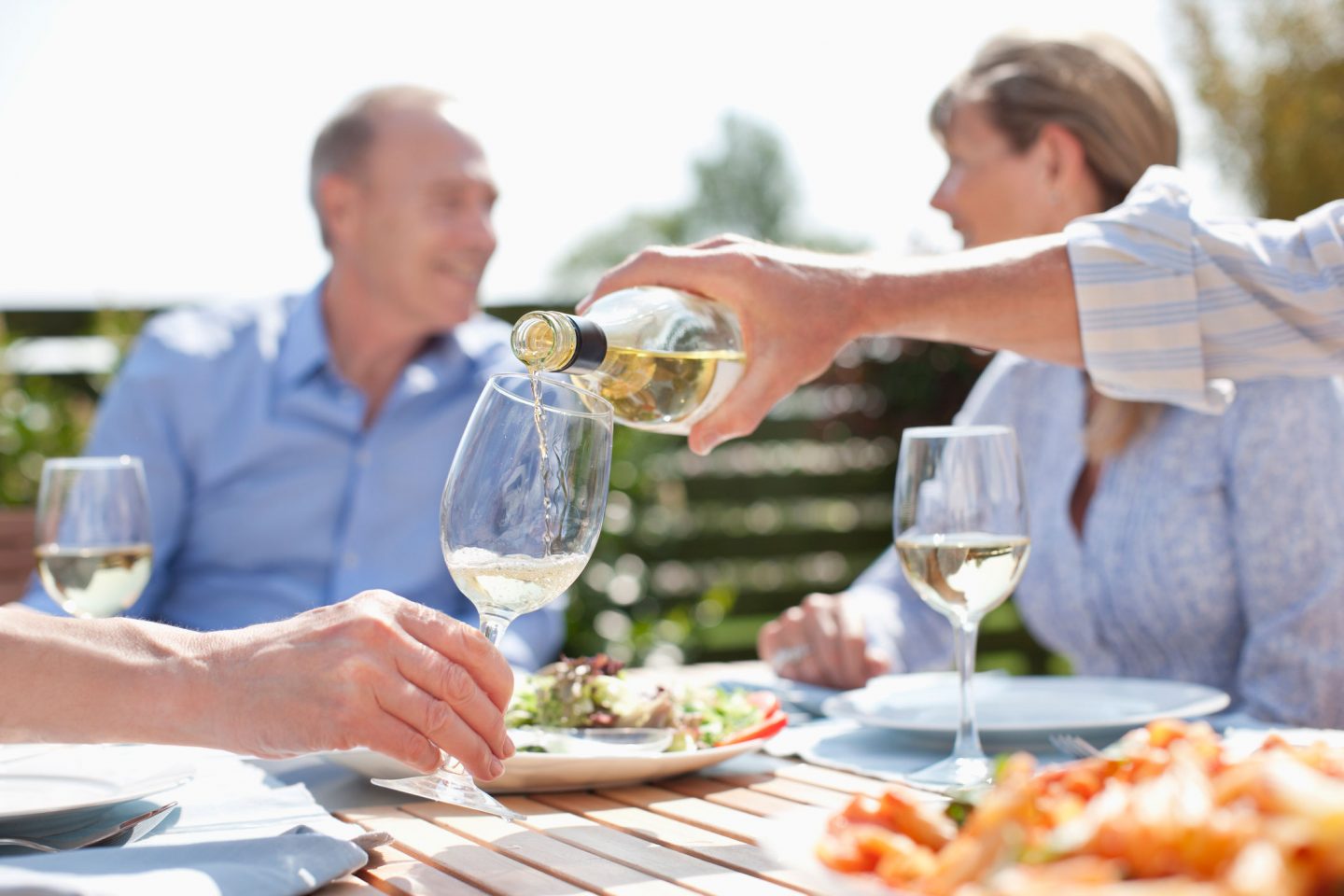 Group sharing wine at holiday cottage in Devon