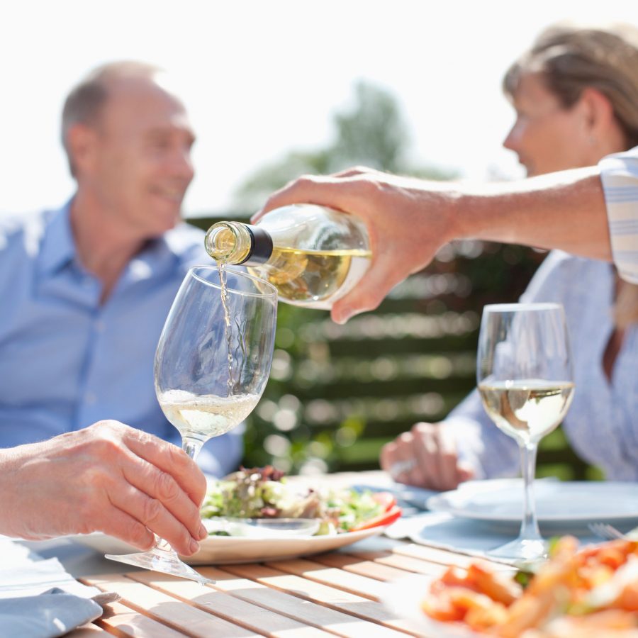 Group sharing wine at holiday cottage in Devon