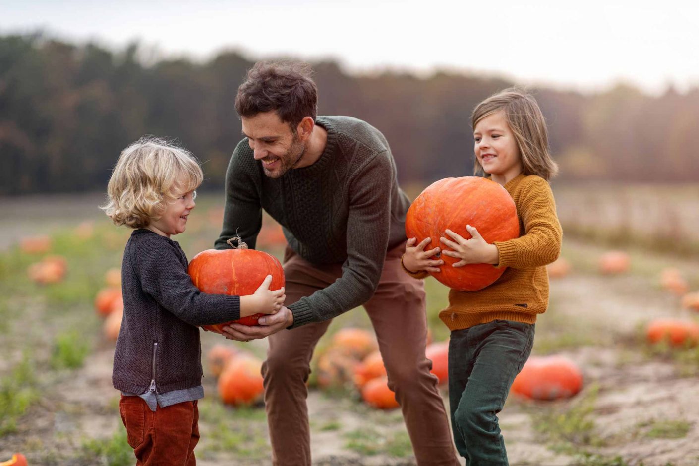 Family picking haloween pumpkins on holiday in North Devon