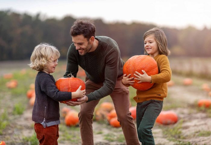 Family picking haloween pumpkins on holiday in North Devon