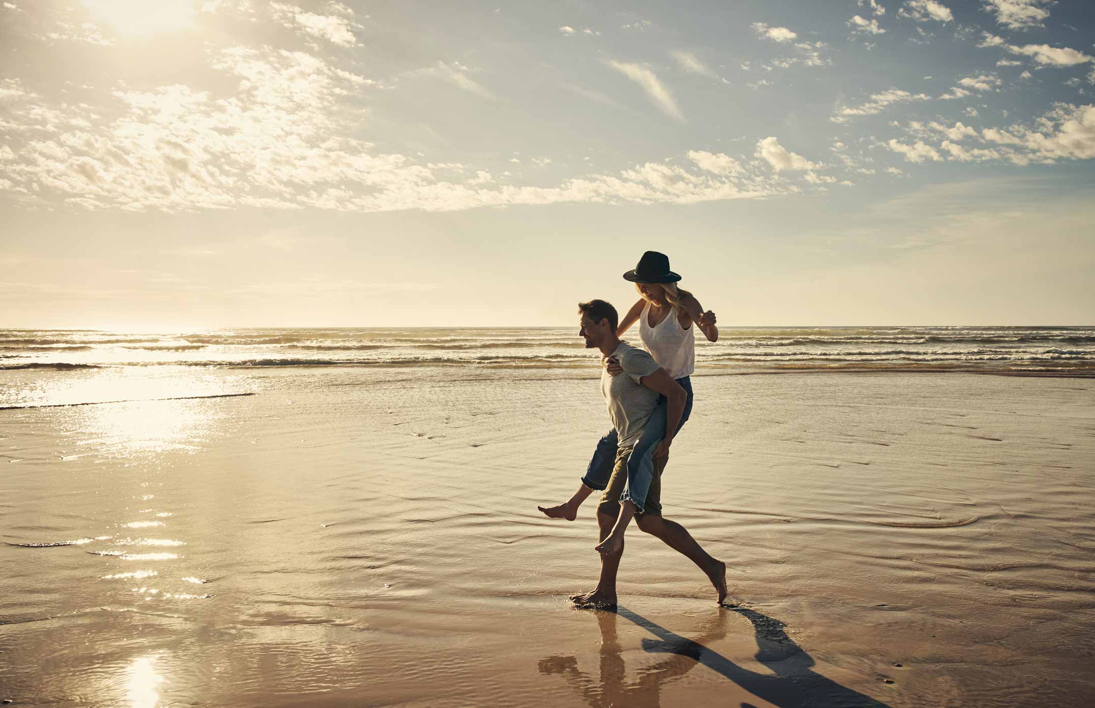 Couple enjoying the beach whilst on holiday