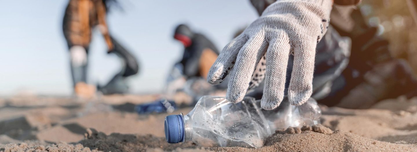 People picking up litter on beach