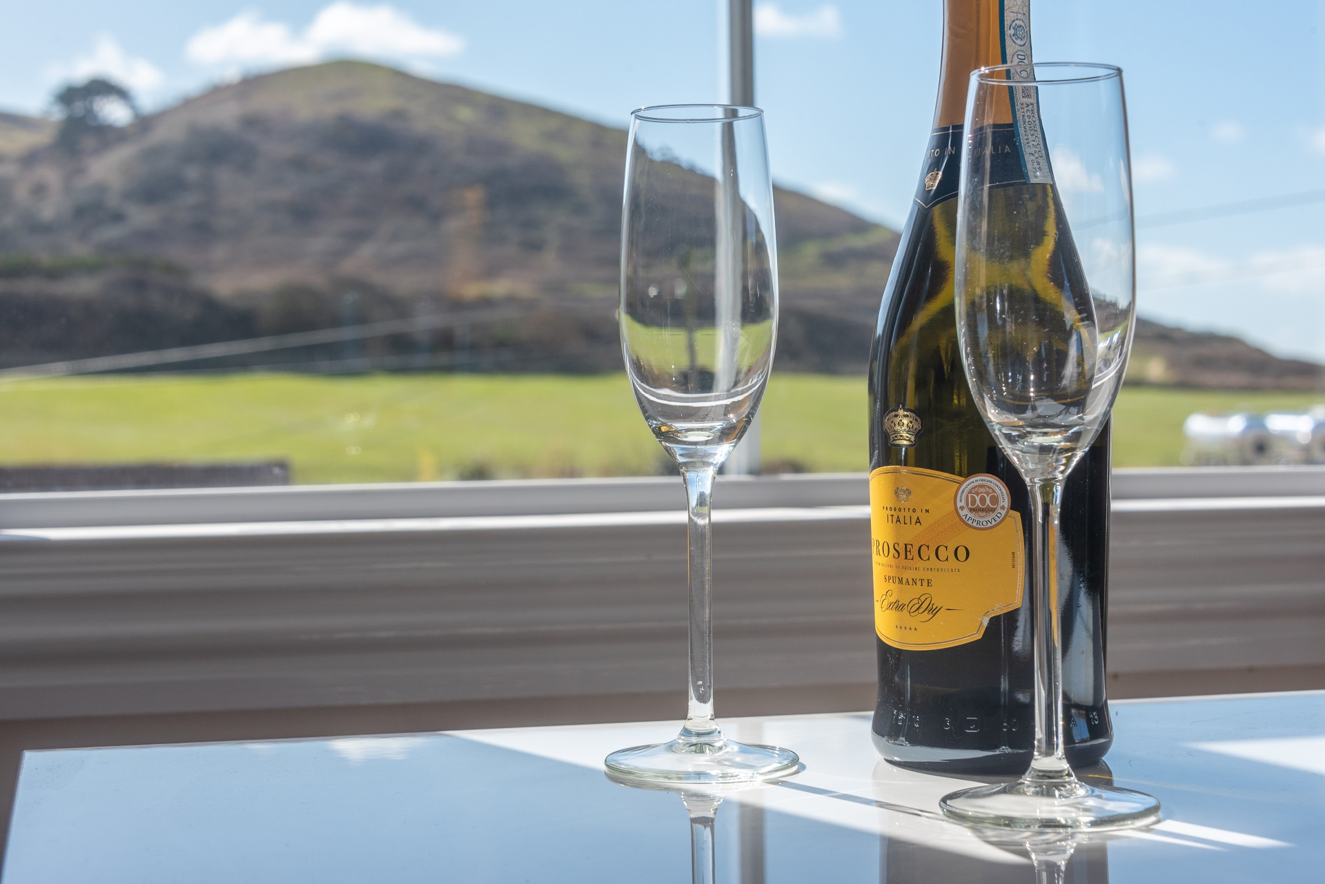 Bottle of Proseco in window of Sea Breeze Holiday Home in Woolacombe