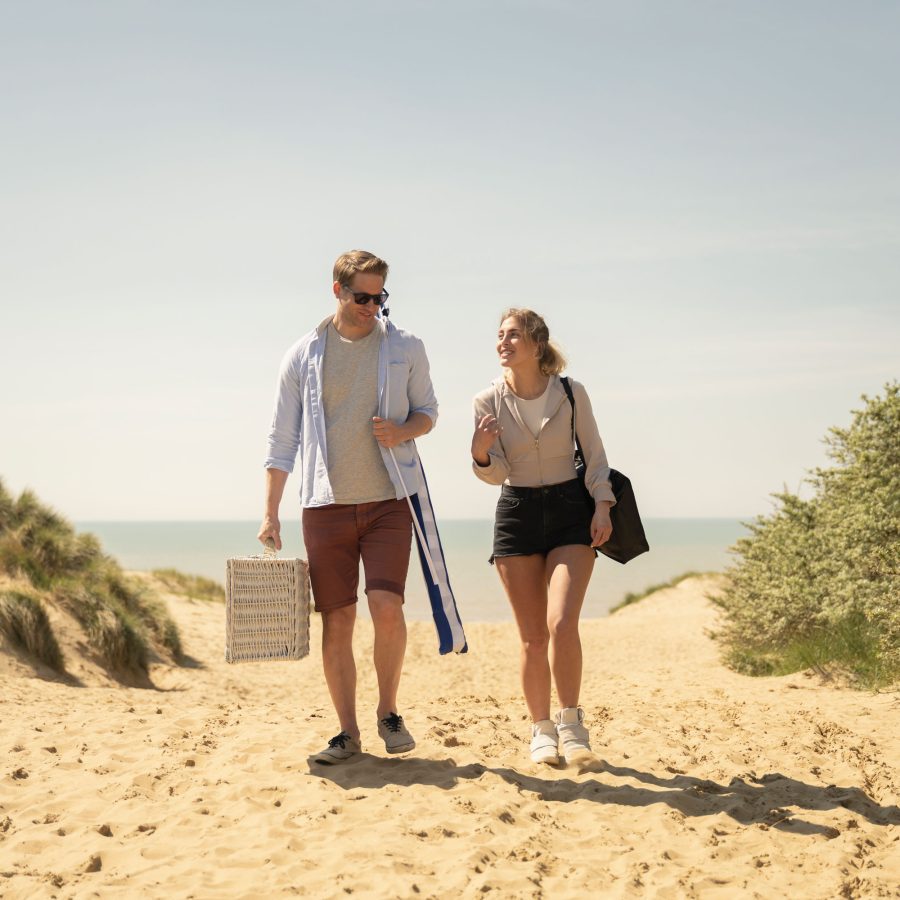 Couple walking on the beach whilst on holiday