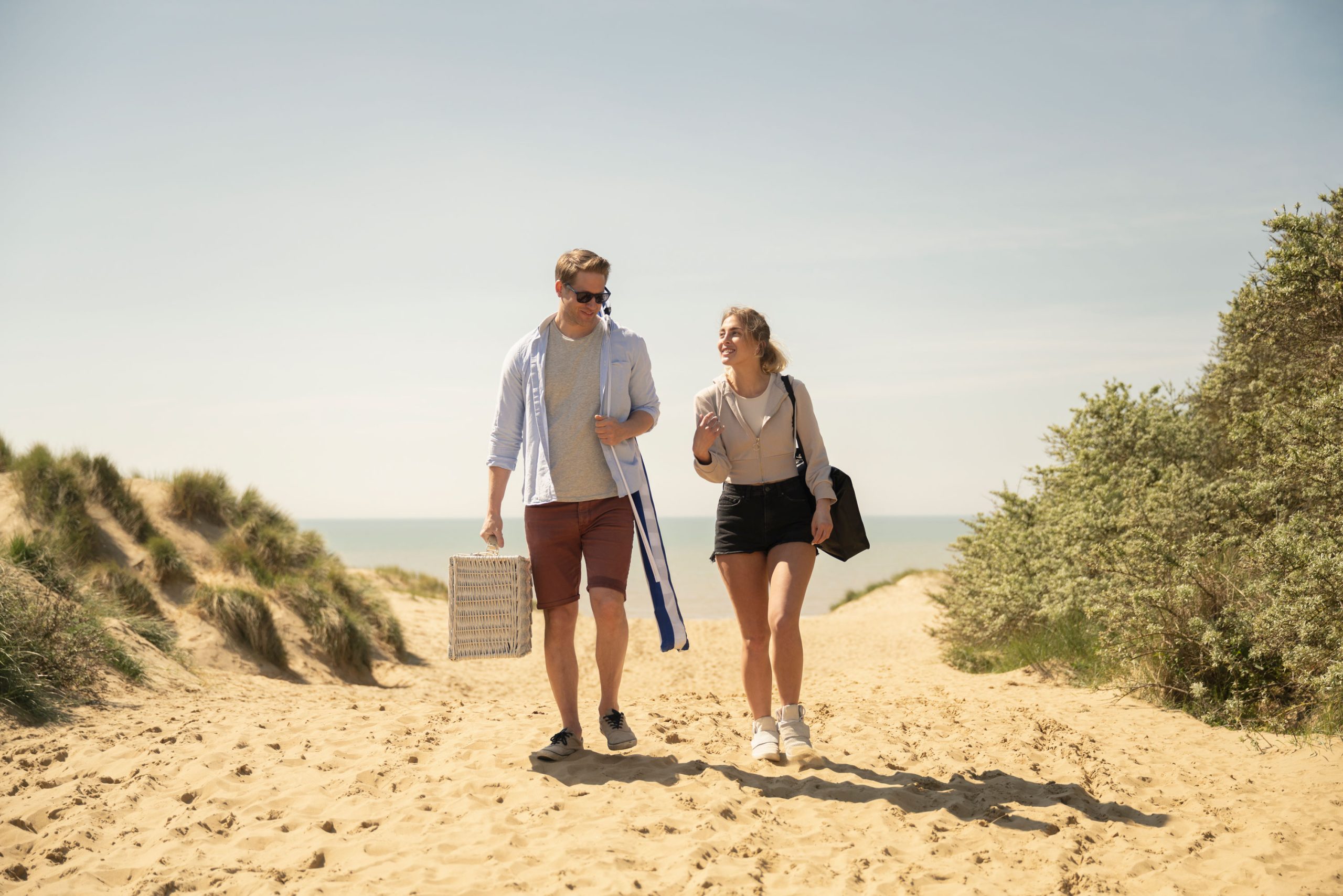 Couple walking on the beach whilst on holiday